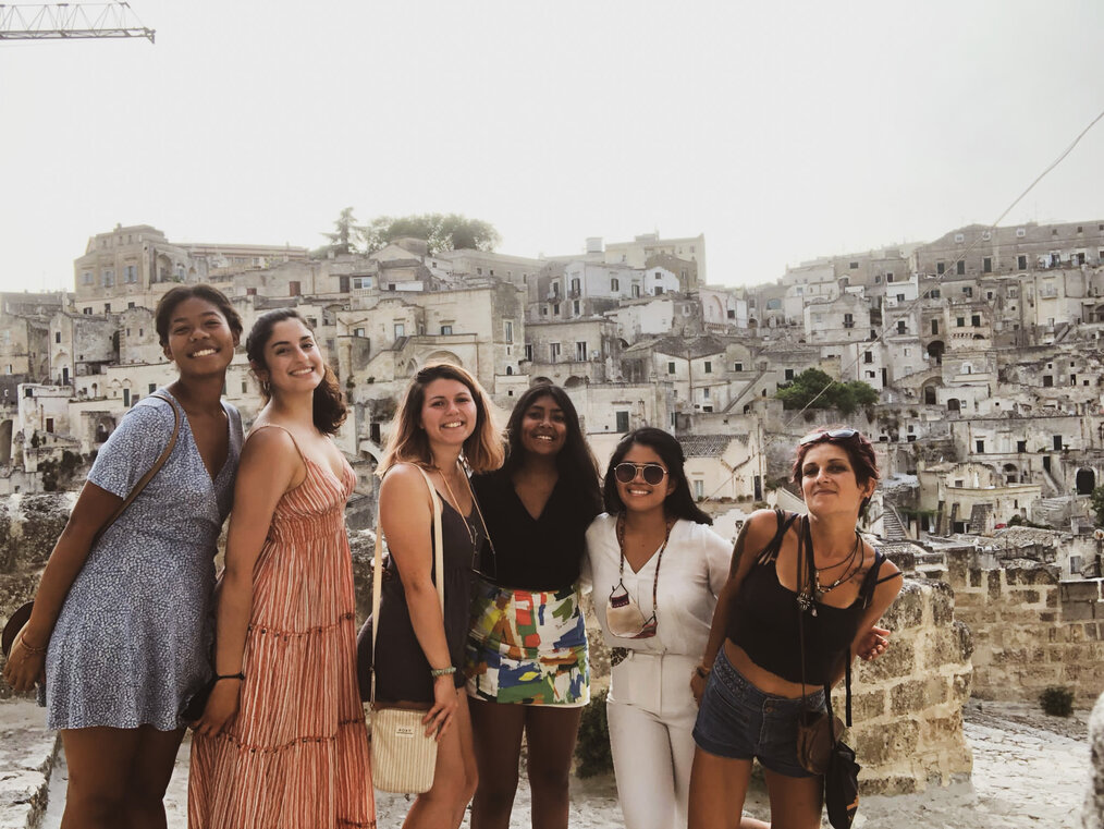A group of women smile for the camera.